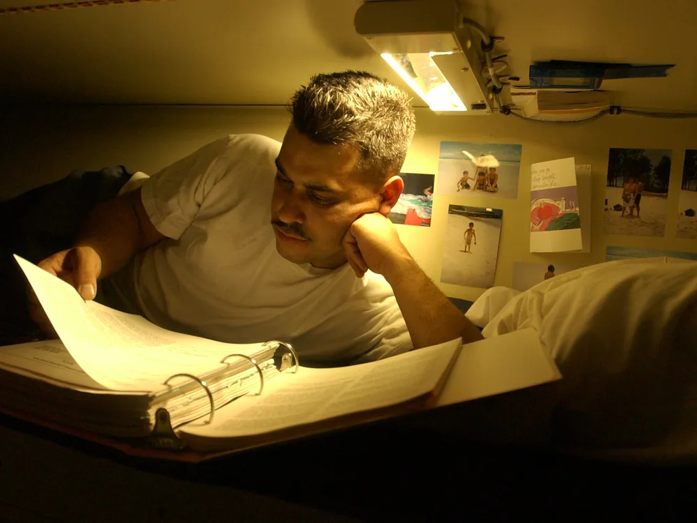A person studying with books and certification prep materials